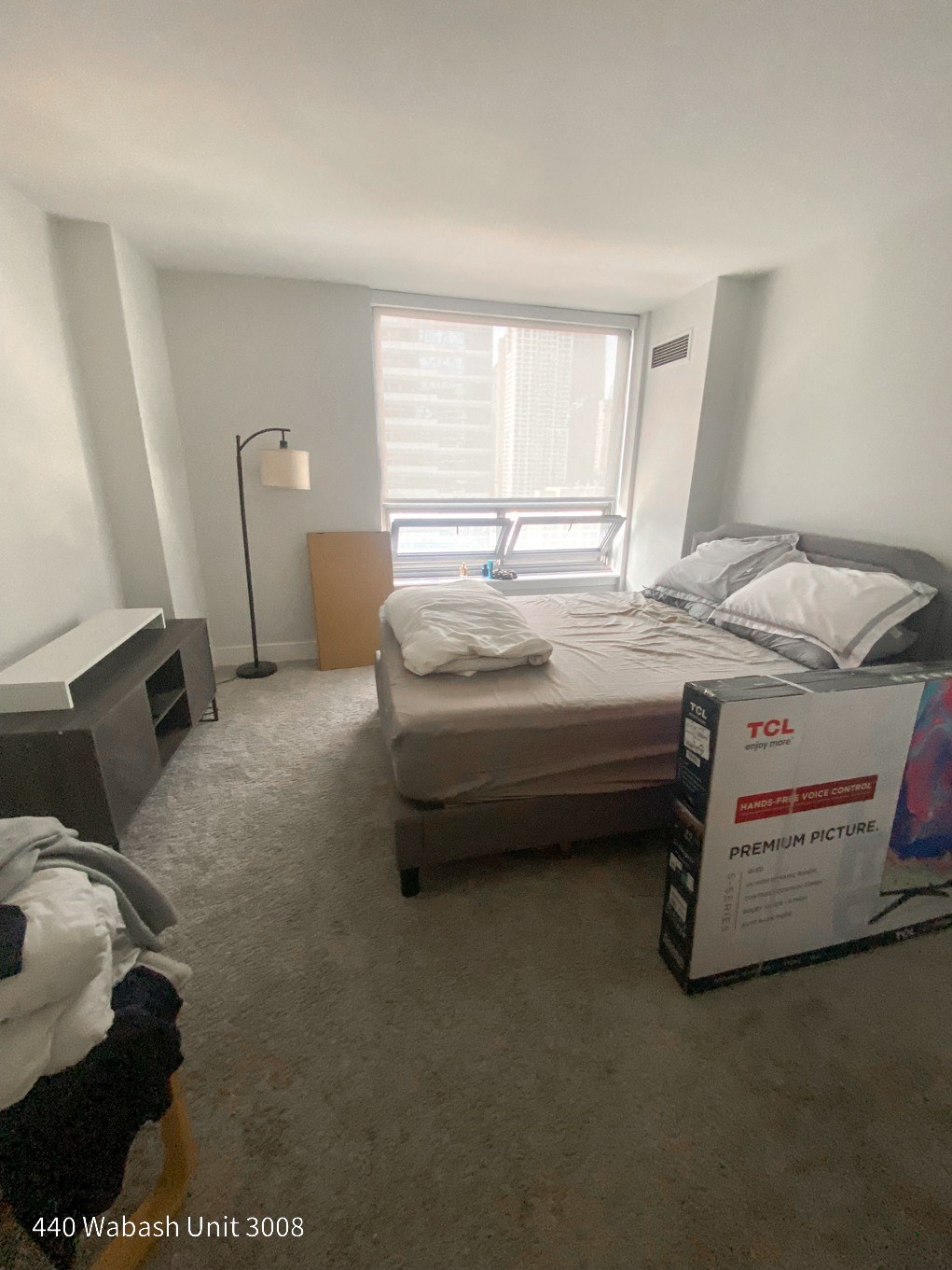 a bedroom with a bed and a window