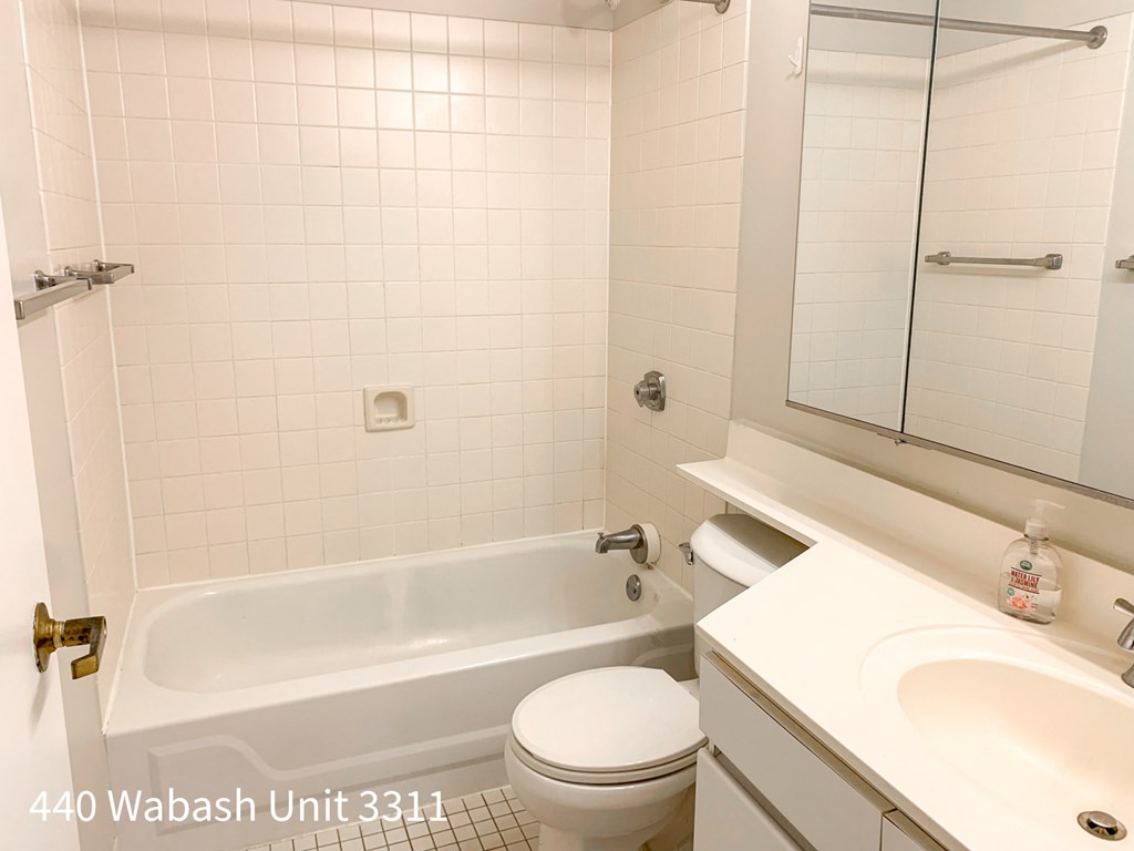 a white bathroom with a toilet sink and tub