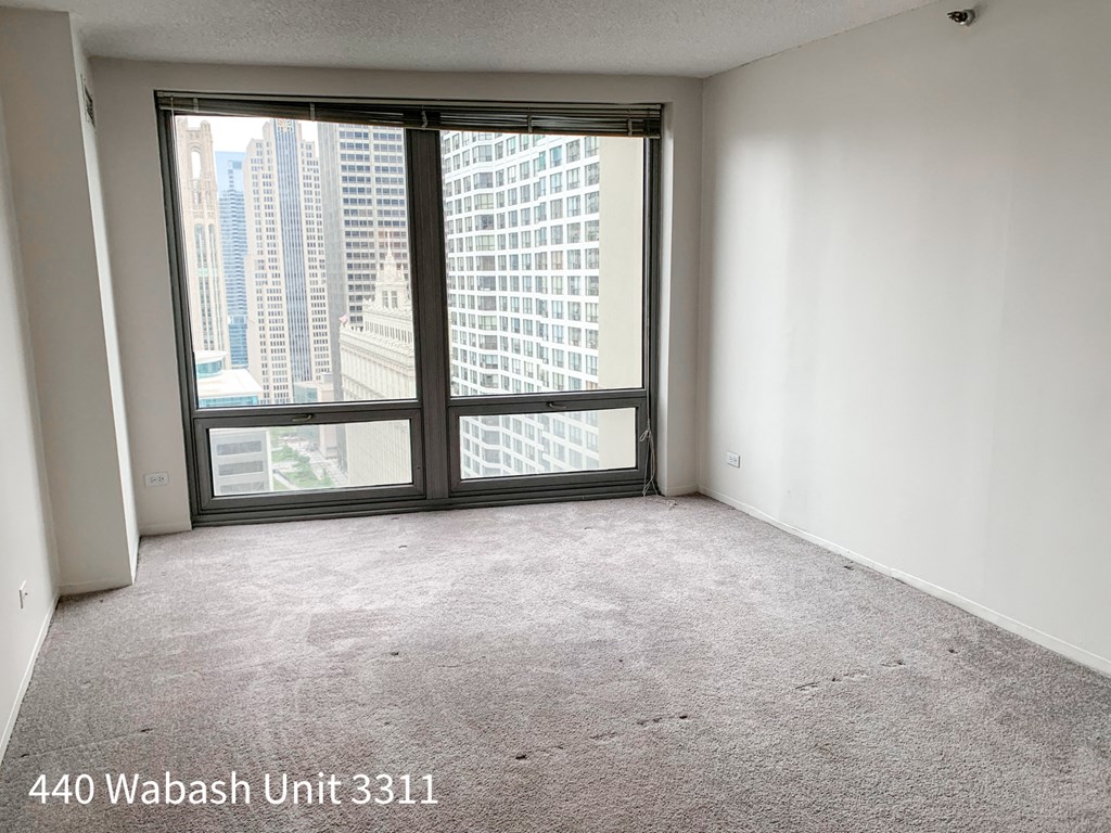 an empty living room with a large window
