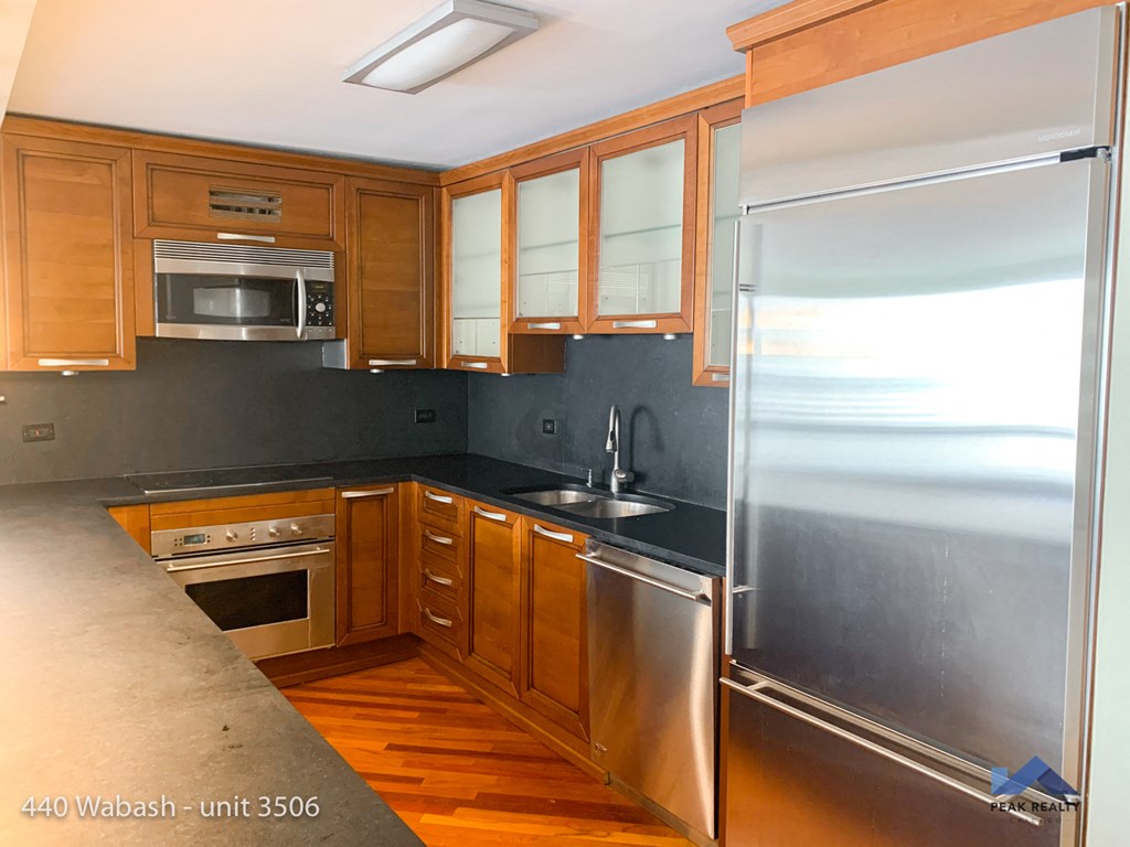 a kitchen with stainless steel appliances and wooden cabinets
