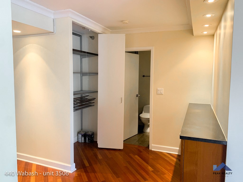 an empty room with a closet and a toilet