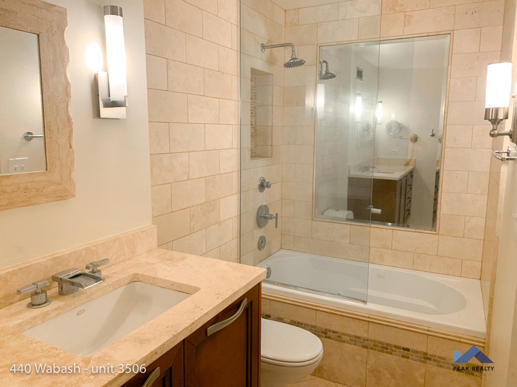 a bathroom with a sink and a shower and a toilet