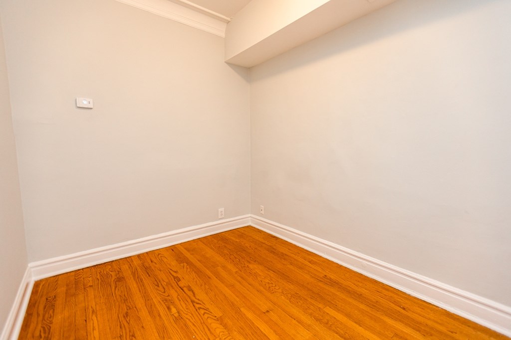 A room with wooden floors and white walls.