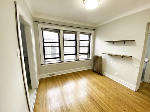 A room with a window and a radiator on the wall.