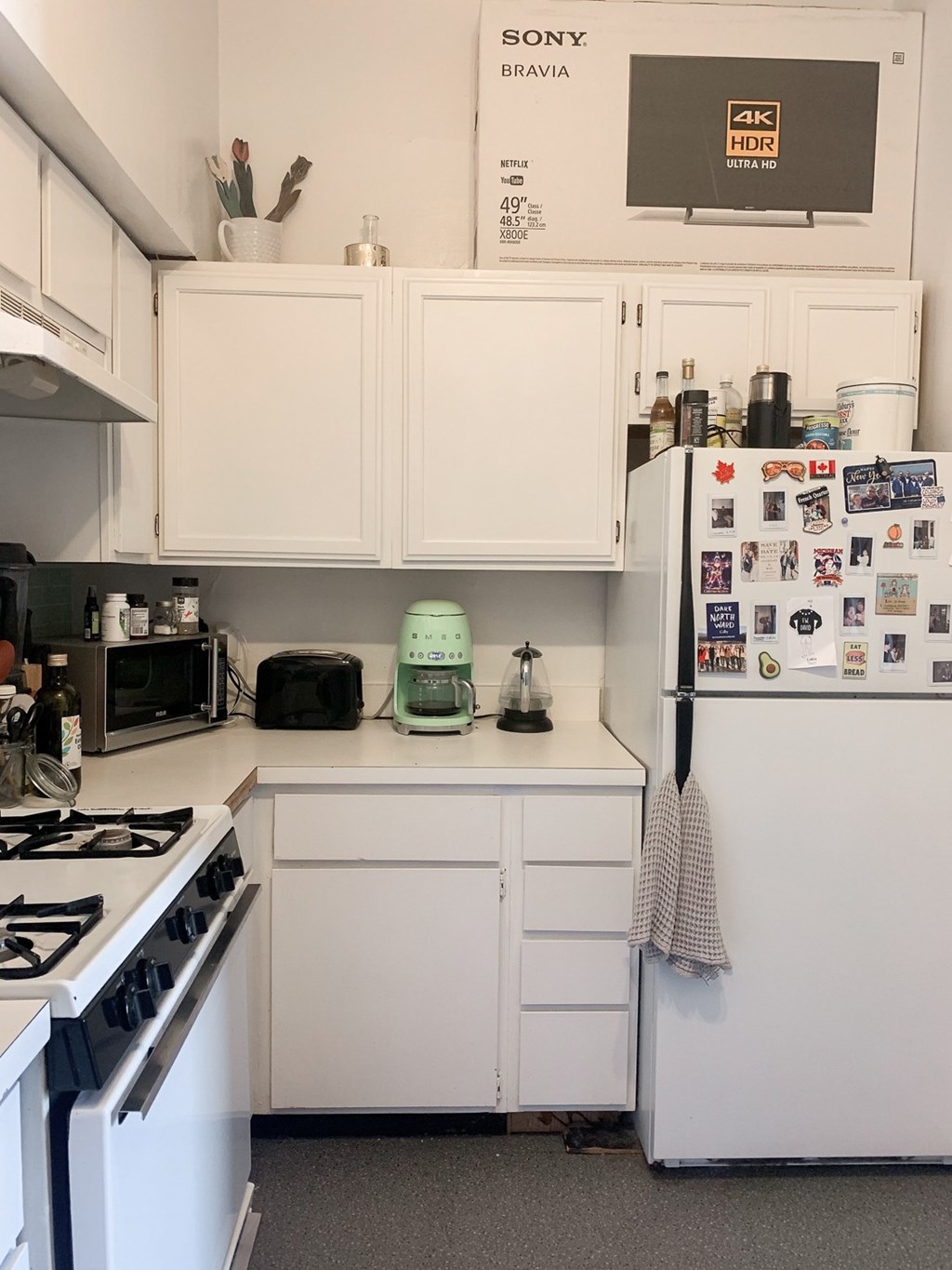 A white fridge with many magnets on it.