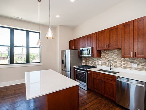 A kitchen with wooden cabinets and stainless steel appliances.