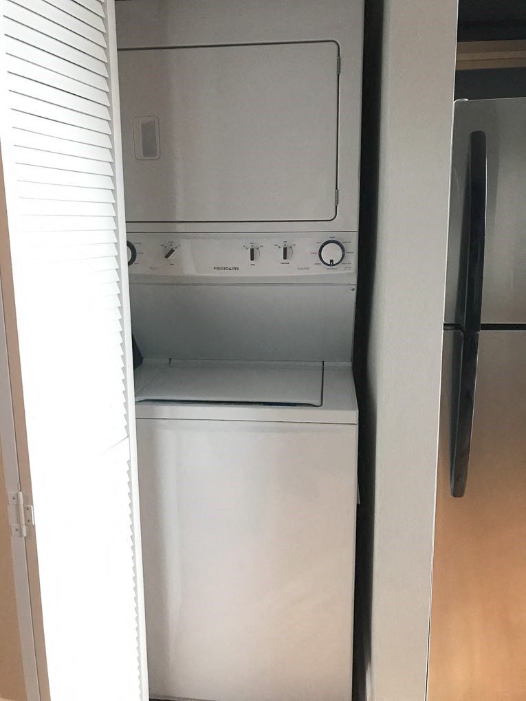 a white washer and dryer in a closet