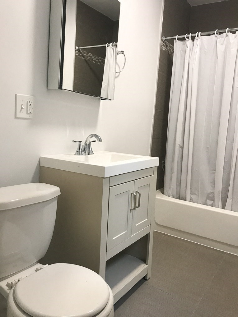 a small bathroom with a sink toilet and shower