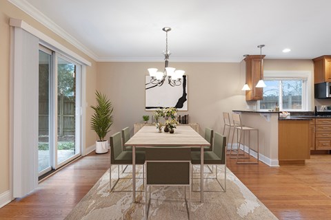 a dining room with a table and chairs and a kitchen