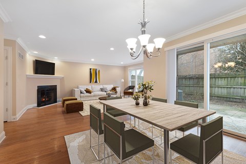 a dining room and living room with a table and chairs