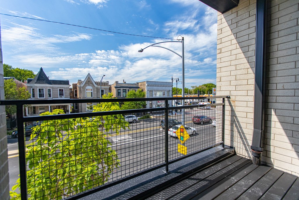 a balcony with a view of a street and buildings