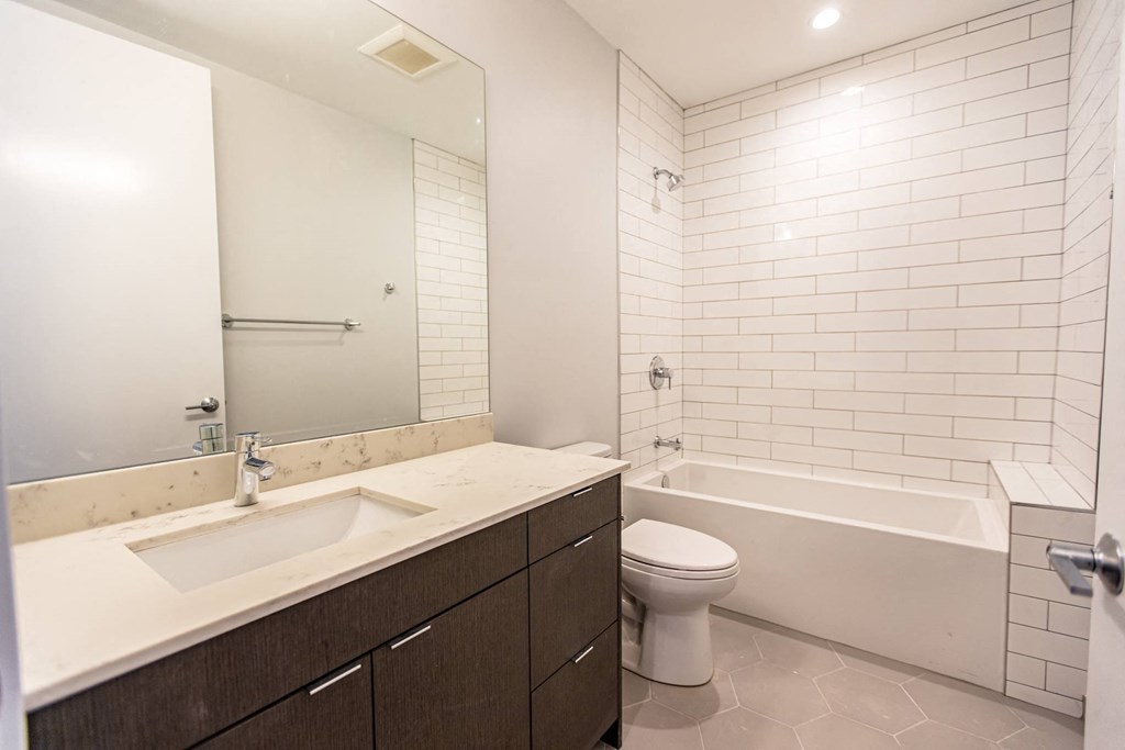 a bathroom with a sink toilet and a bath tub