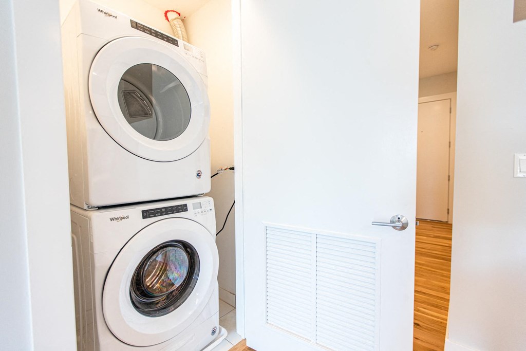 a washer and dryer in a laundry room with a white door