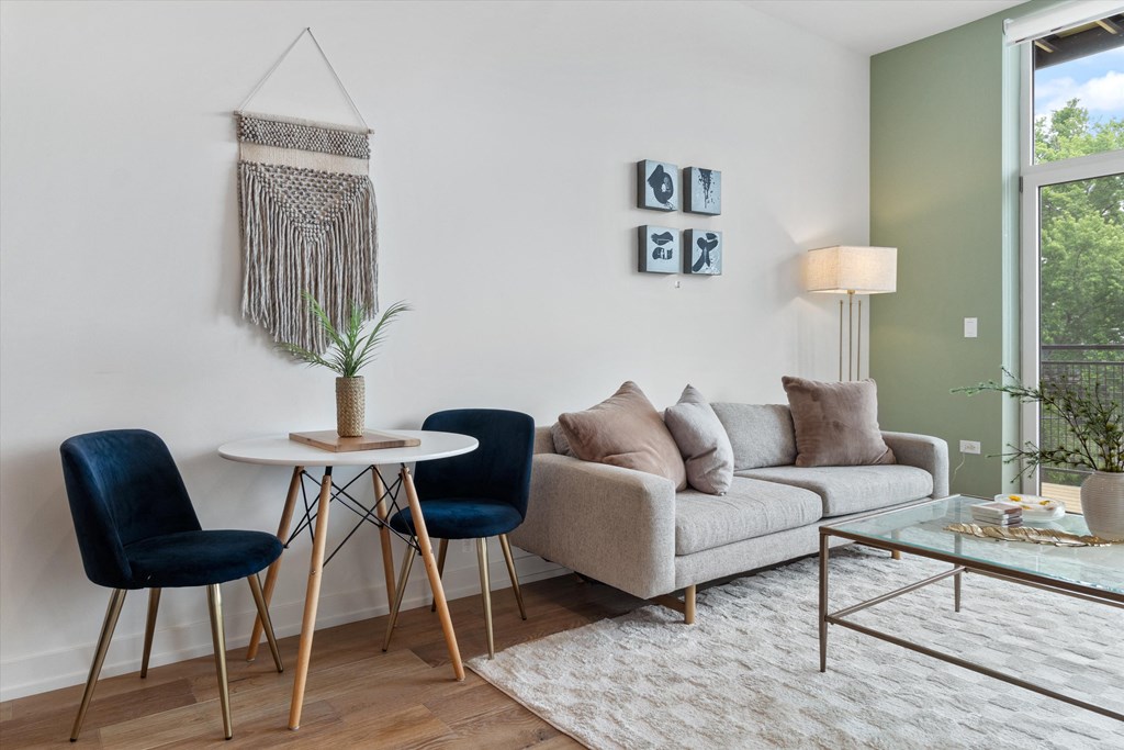 a living room with a couch and a table with two chairs