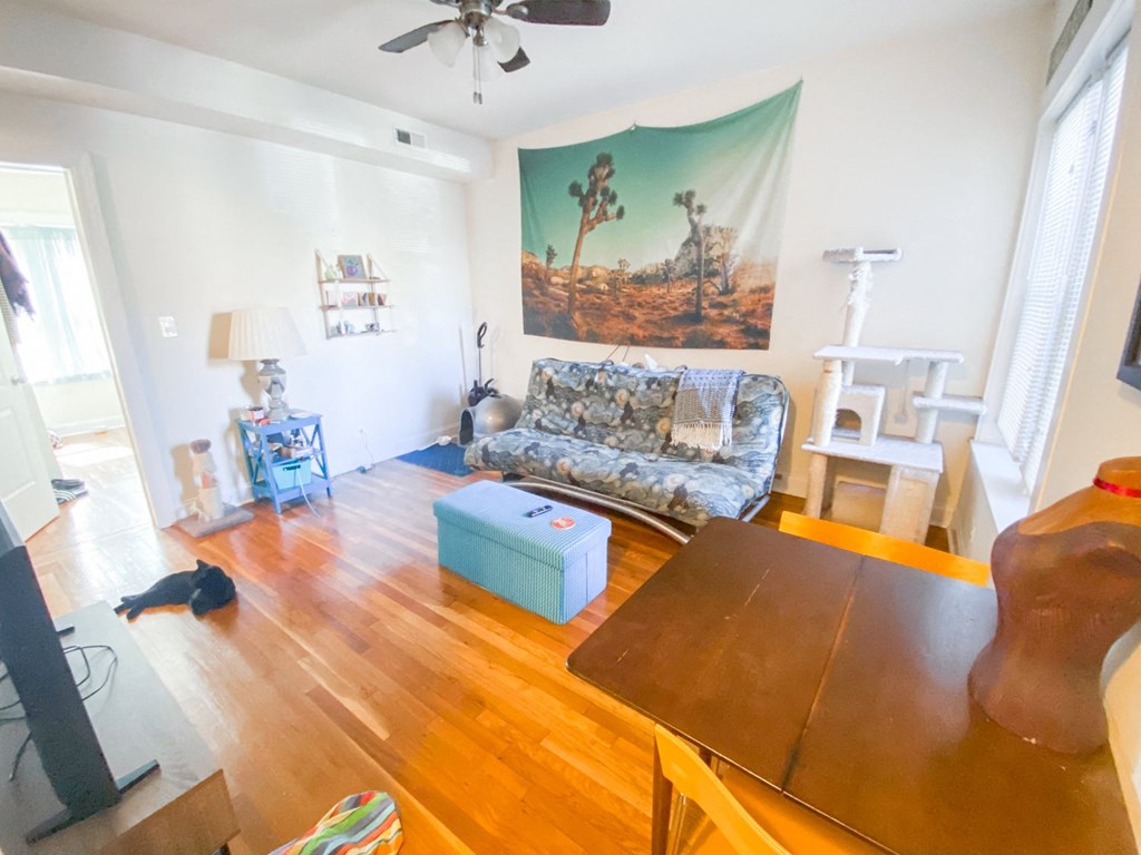 a living room with a wooden floor and a couch and a table