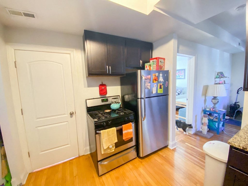 a kitchen with stainless steel appliances and a refrigerator
