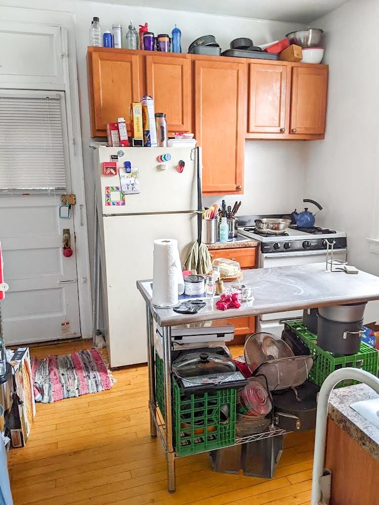 a kitchen with a white refrigerator freezer next to a stove top oven