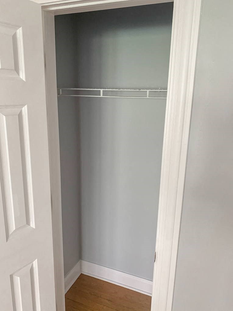 a hallway with a closet with a white door