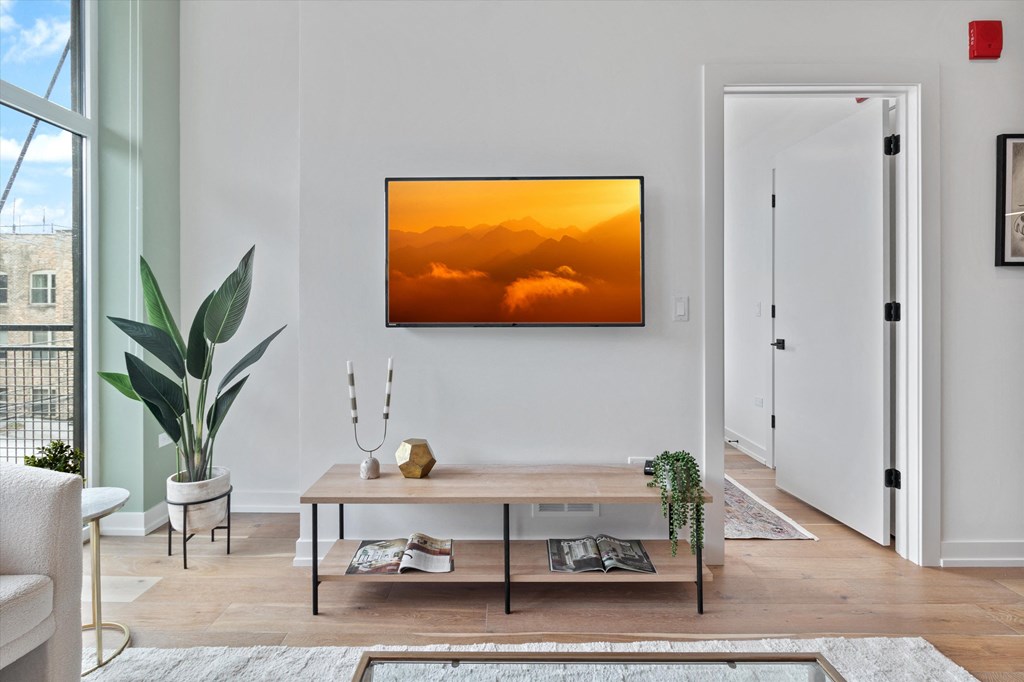 the frame displaying a painting of a sunset in a living room