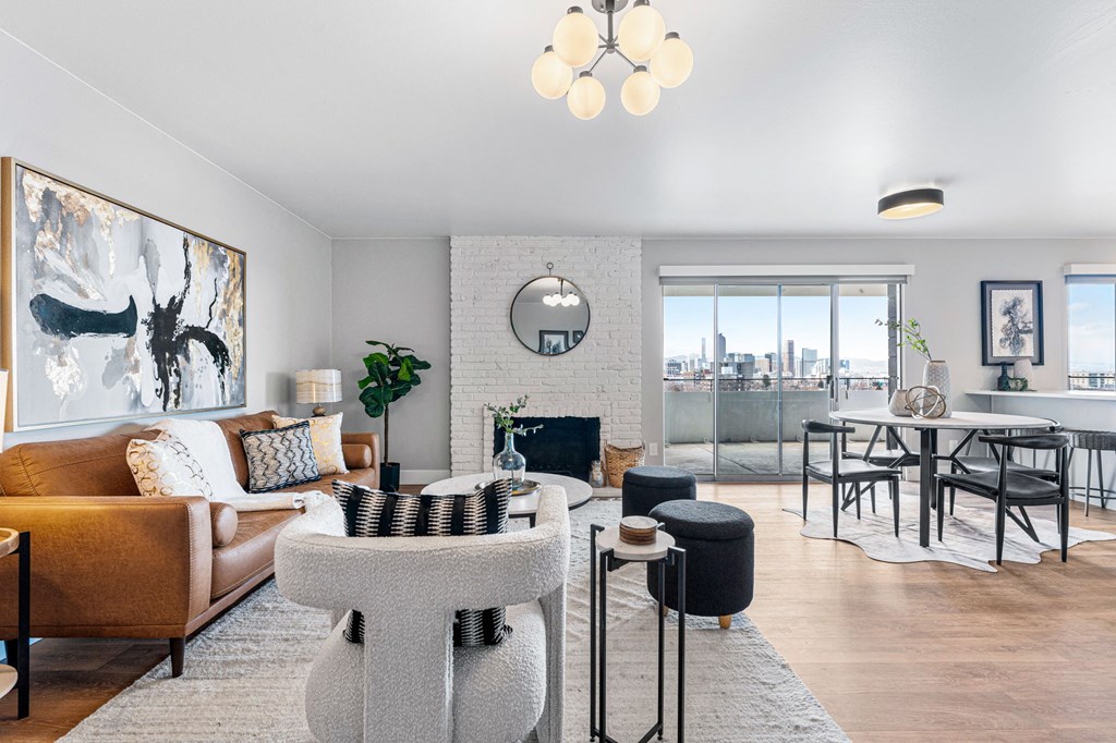 a spacious, open-concept living room with a couch and a table and a fireplace