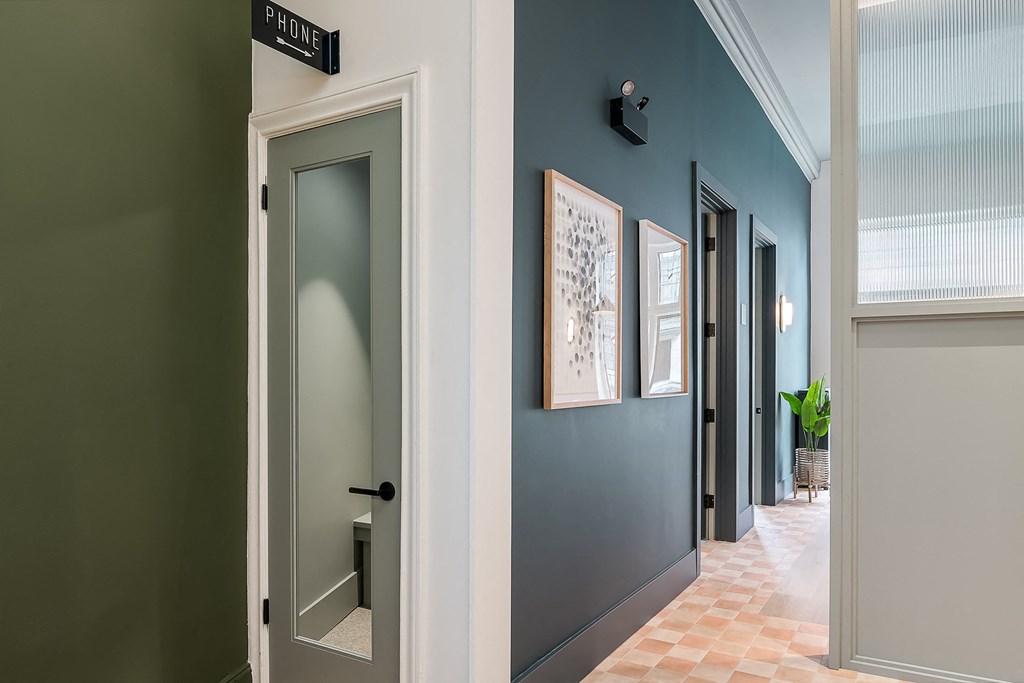 a hallway with blue walls and a door with a street sign on it