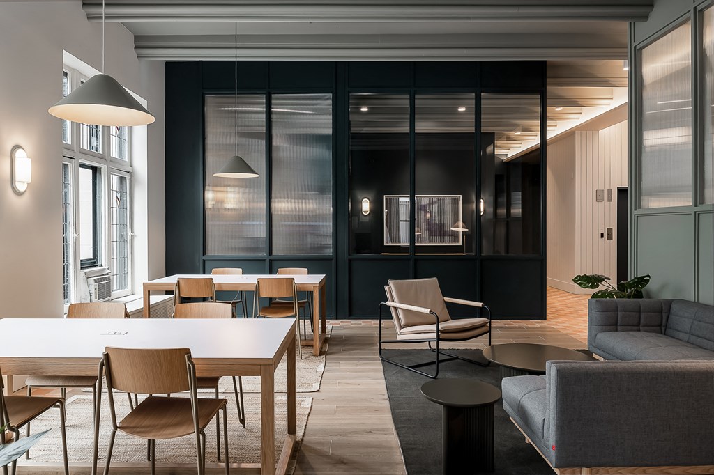a dining room with tables and chairs and a living room