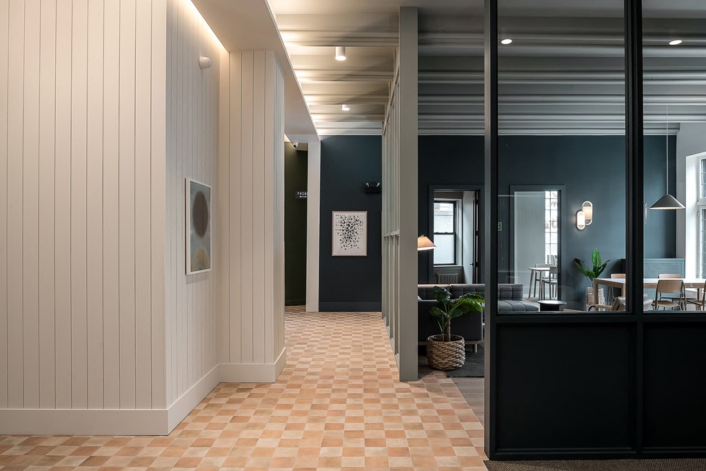a view of a hallway with a lobby and a reception desk