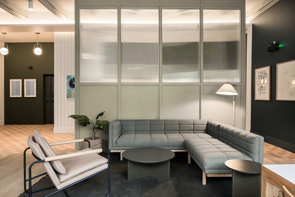 a living room with a gray couch and a table