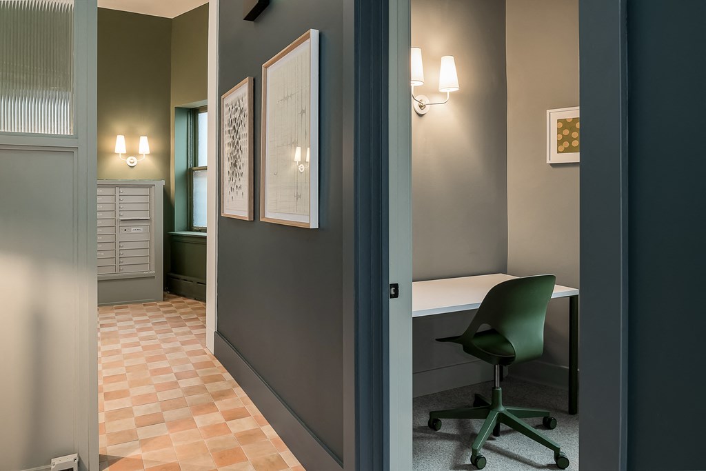 a room with a desk and a chair and a door