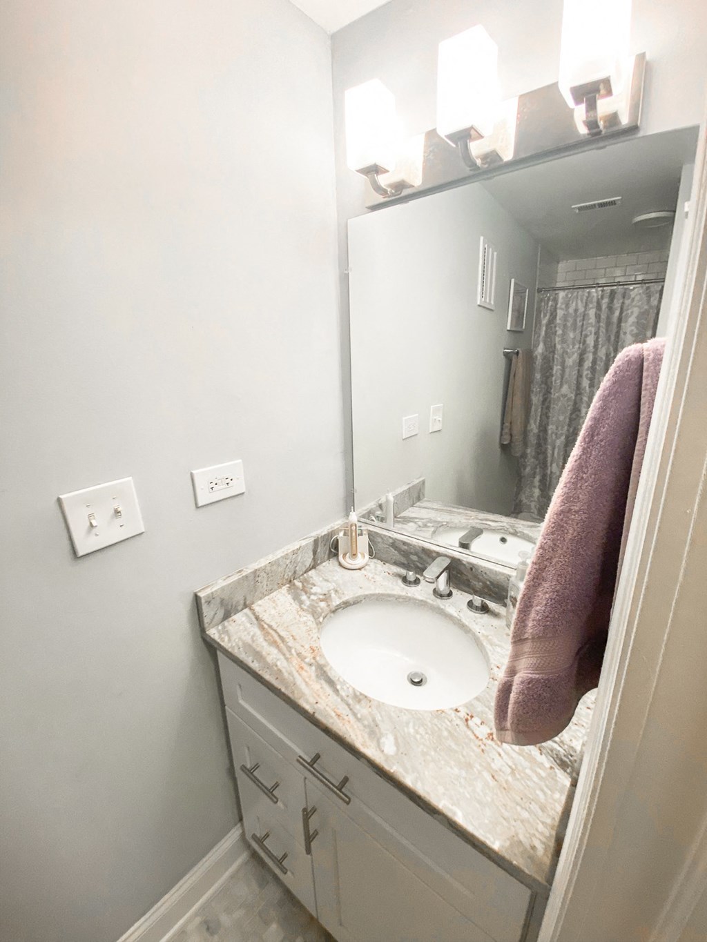a small bathroom with a sink and a mirror