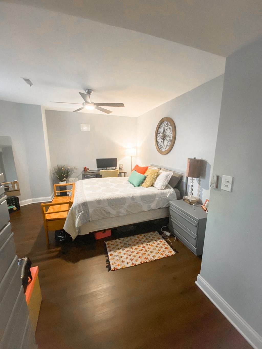 a bedroom with a bed and a ceiling fan