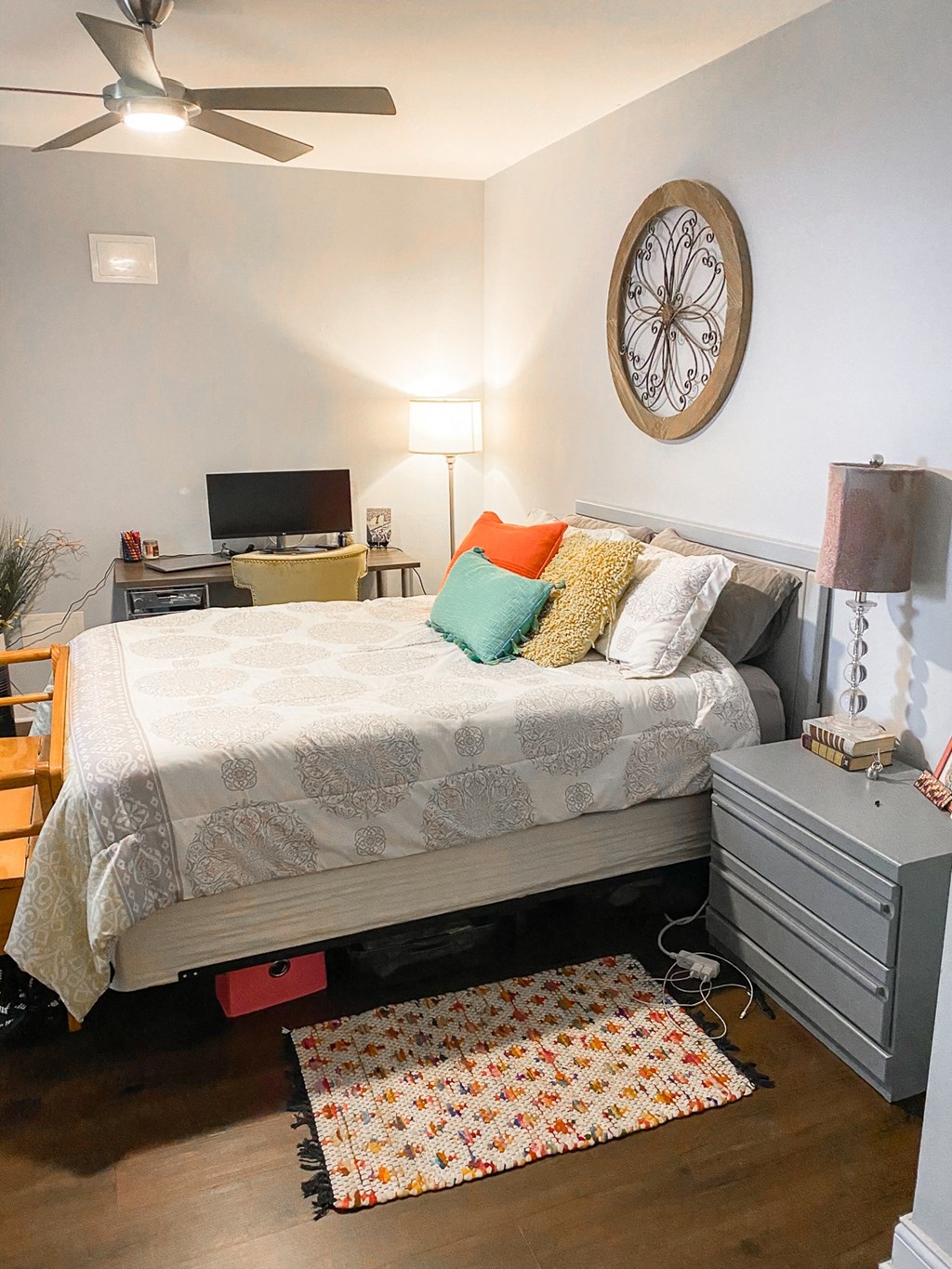a bedroom with a bed and a clock on the wall