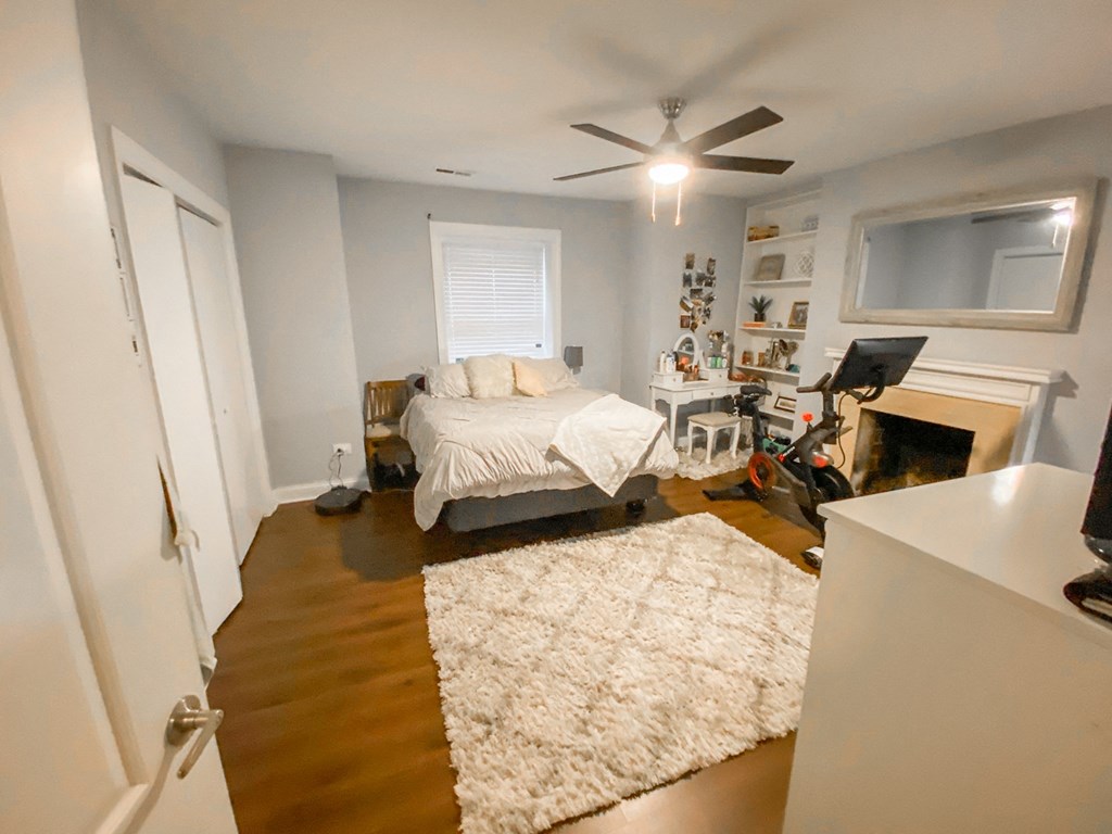 a bedroom with a bed and a ceiling fan