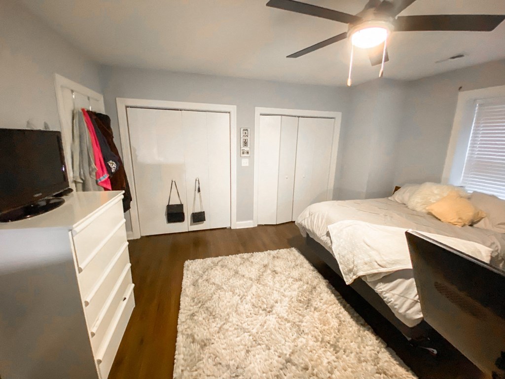 a small bedroom with a bed and a tv