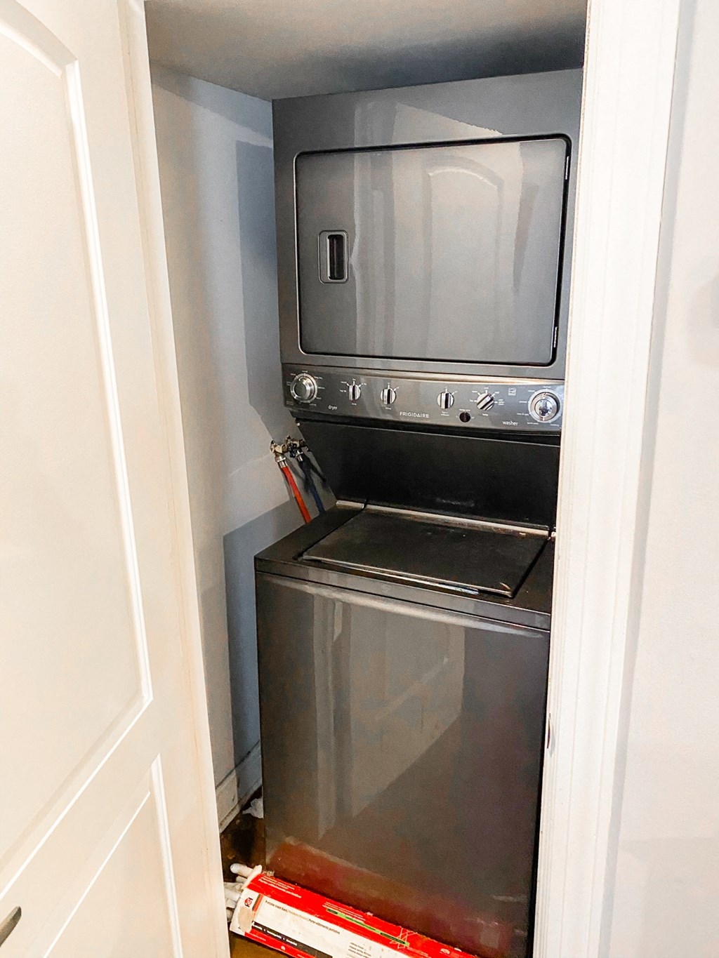 a small laundry room with an oven and a washer and dryer