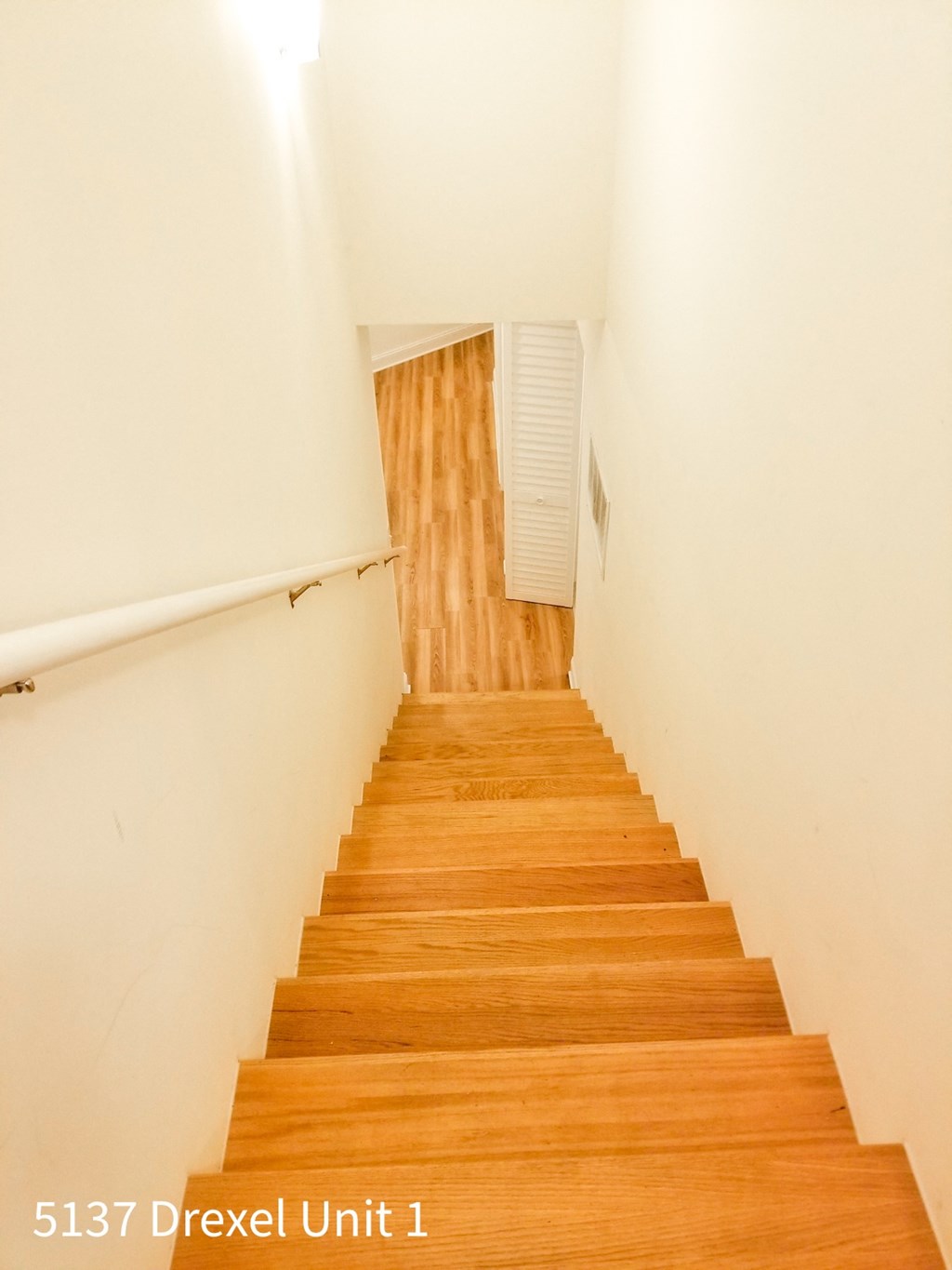 a view of the stairs from the top of the staircase in a home with wood