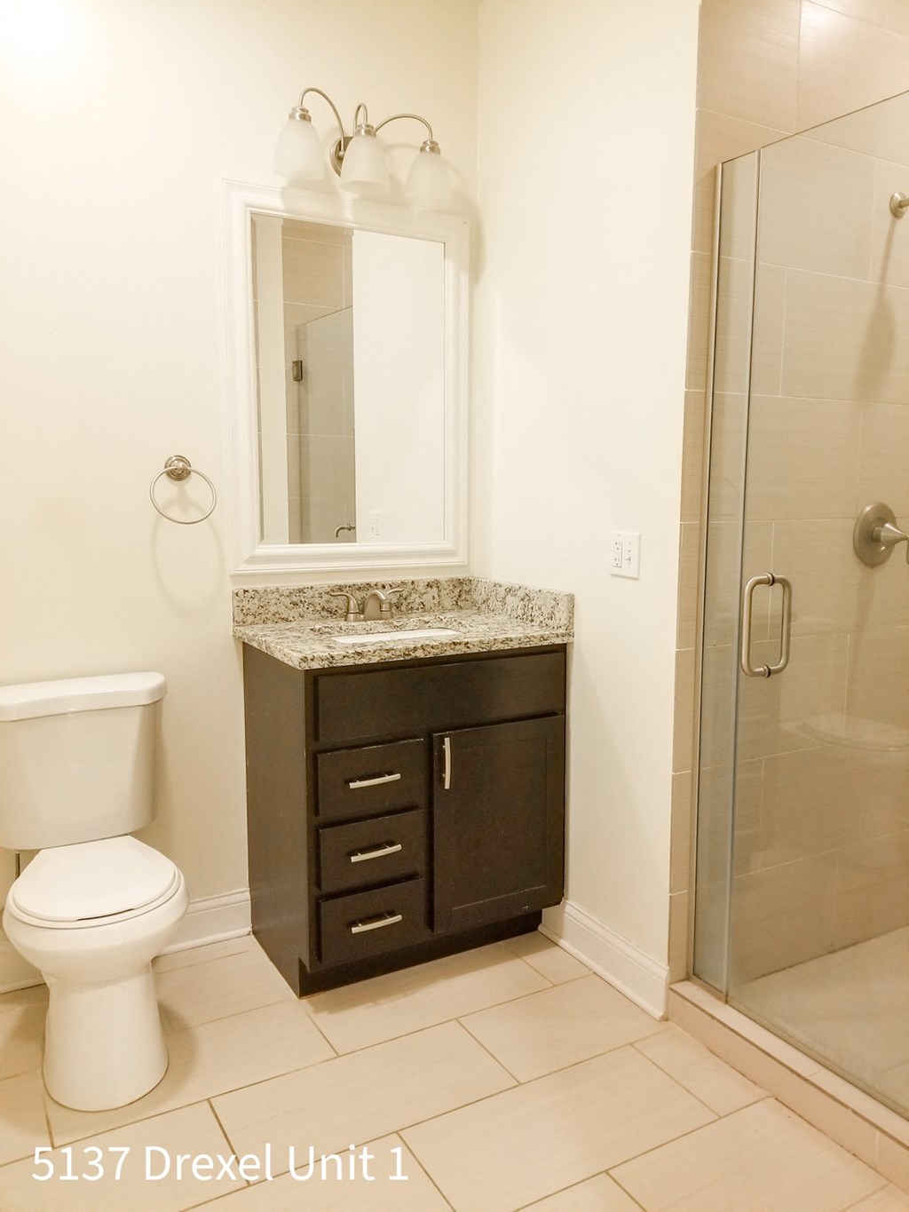 a bathroom with a toilet and a sink and a shower