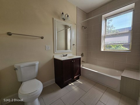 a bathroom with a toilet and a sink and a bath tub