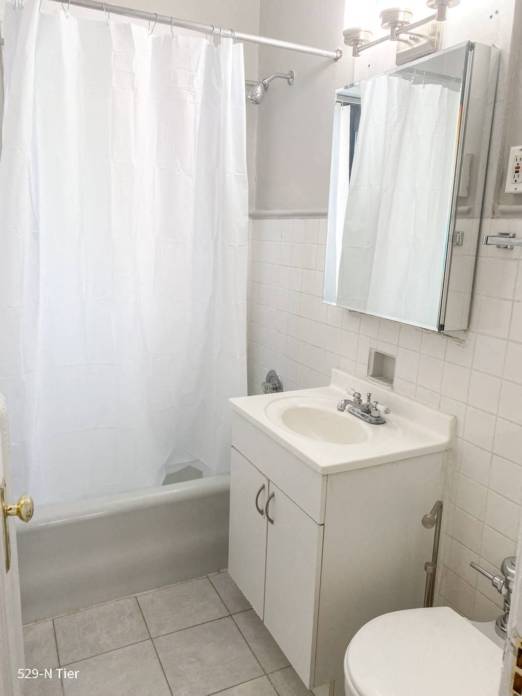 a bathroom with a sink and a shower and a mirror