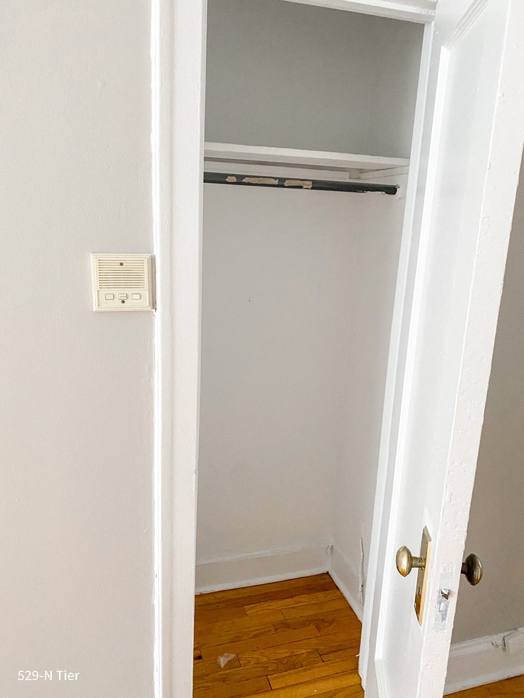 an empty closet in a room with a door open