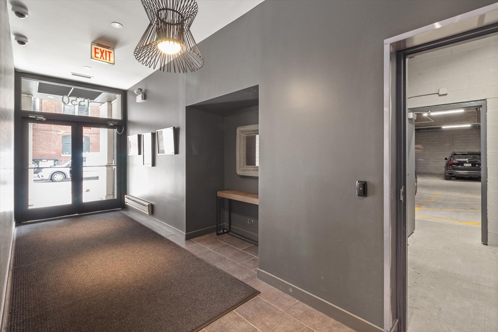 a hallway in a building with a door to a parking lot