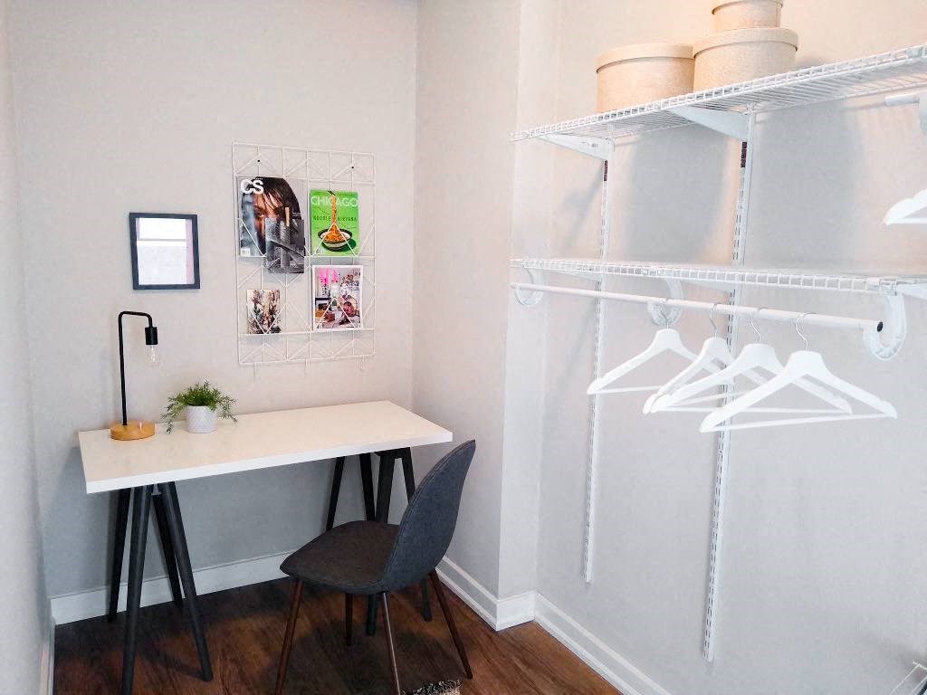 a desk with a chair in a room with a closet