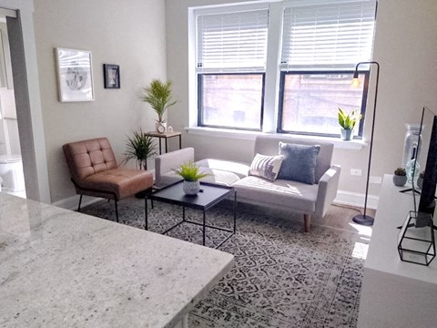 a living room with a couch and a window