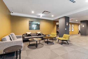 a living room with couches and chairs