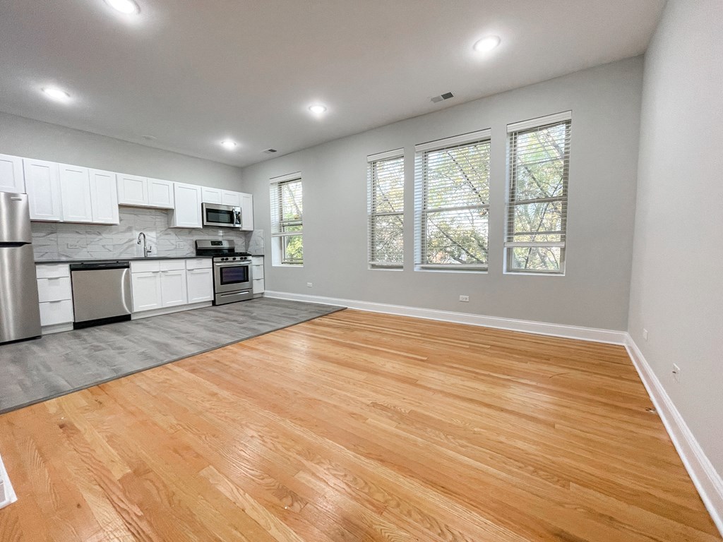 a large room with wooden floors and windows