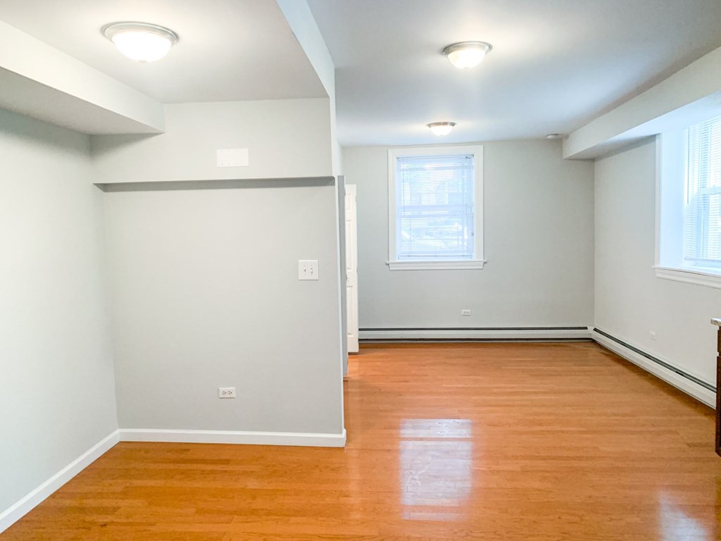 A room with wooden floors and white walls.
