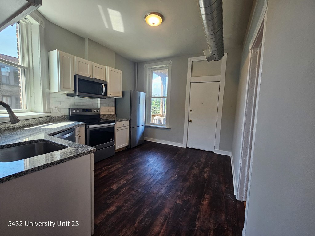a kitchen with a sink and a stove and a window