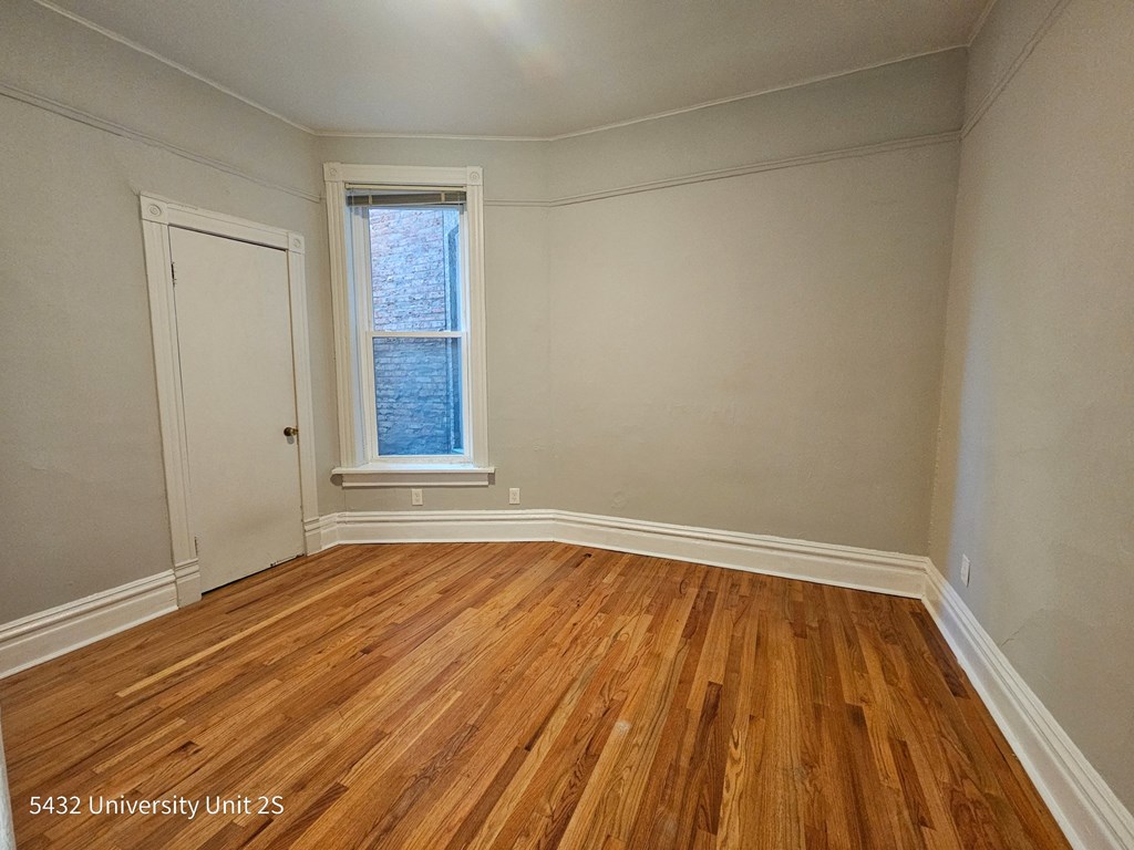 the living room of a house with wooden floors and a window
