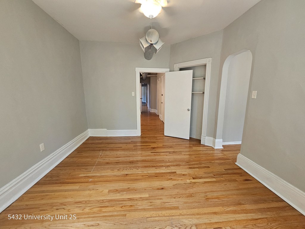 a renovated living room and hallway with wood flooring
