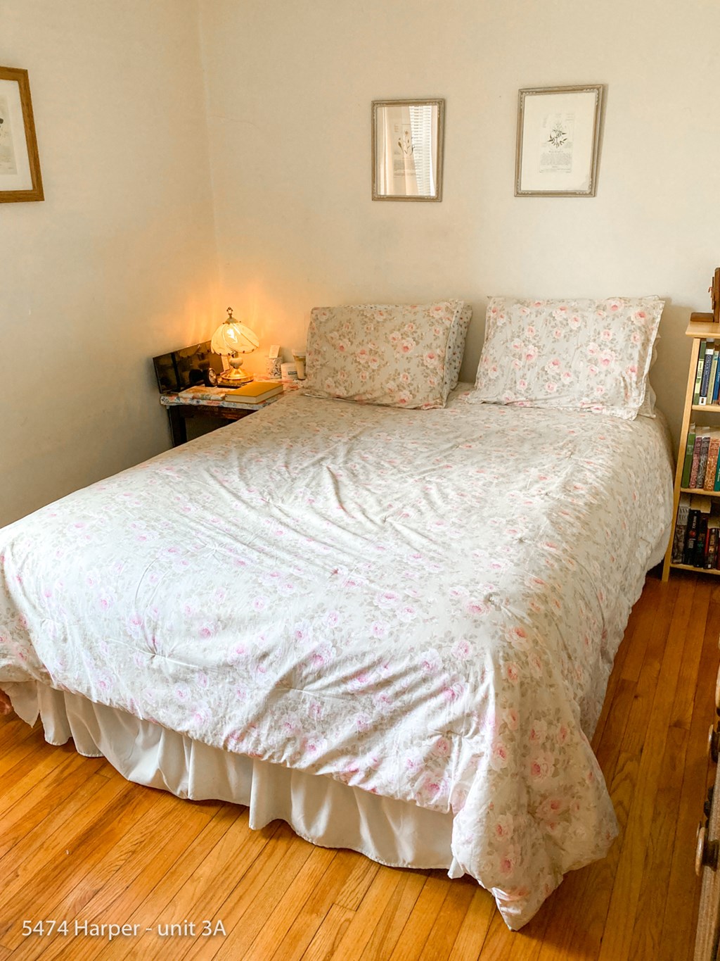 a bedroom with a bed with a white comforter